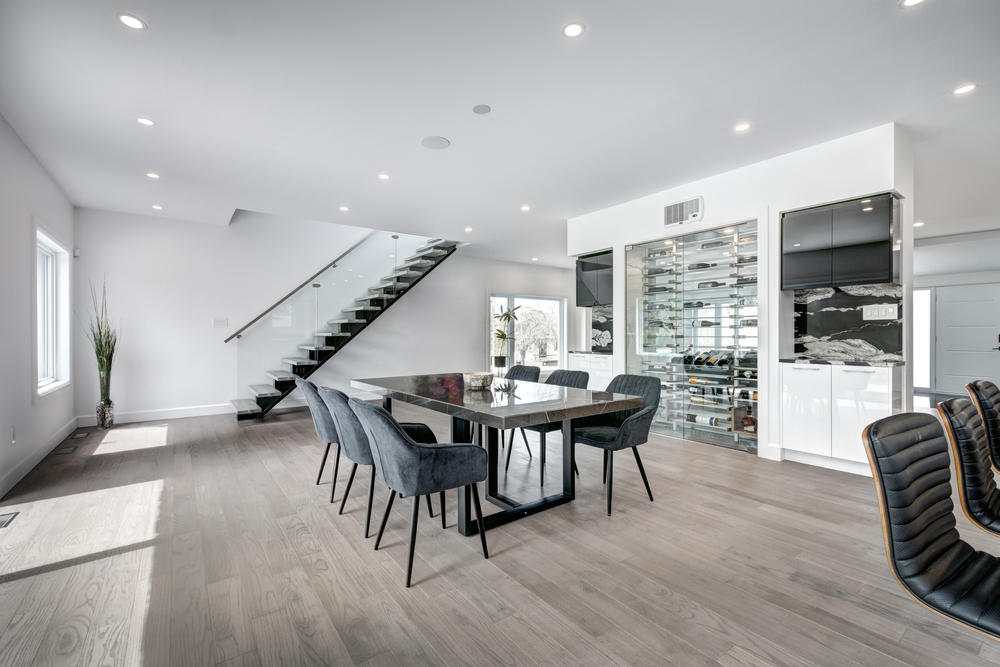 Modern dining area featuring custom basement renovation services with stylish finishes and functional design