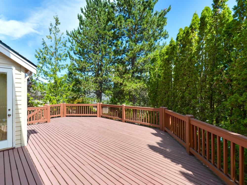 Professional deck builders constructing a composite deck with precision trim details in Spokane Valley