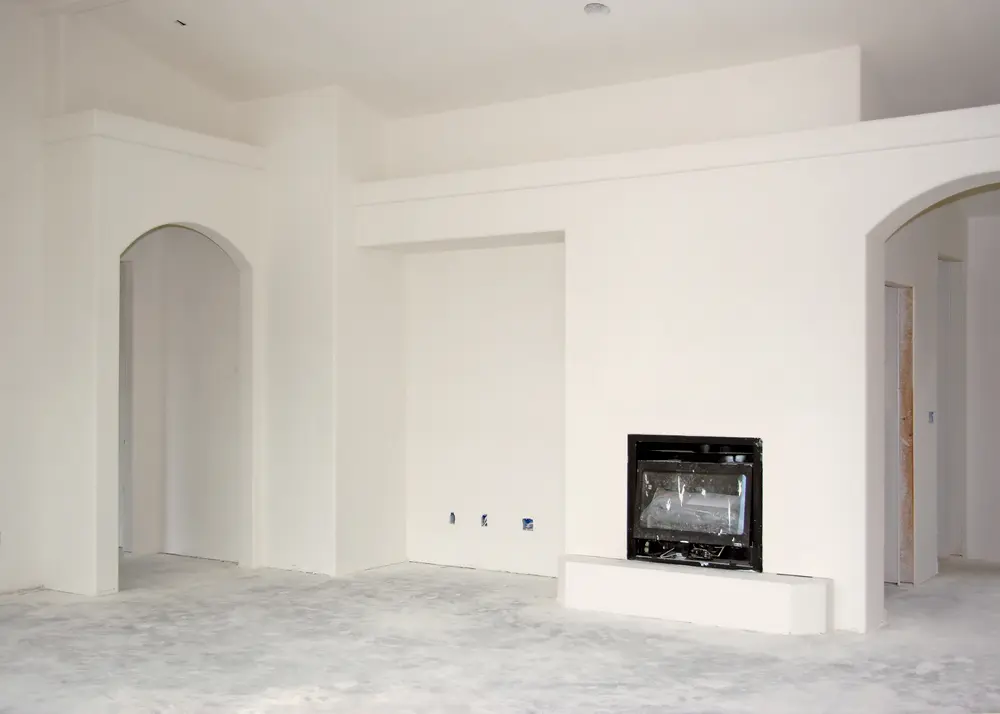 Smooth finished drywall installation with white painted walls in a renovated interior